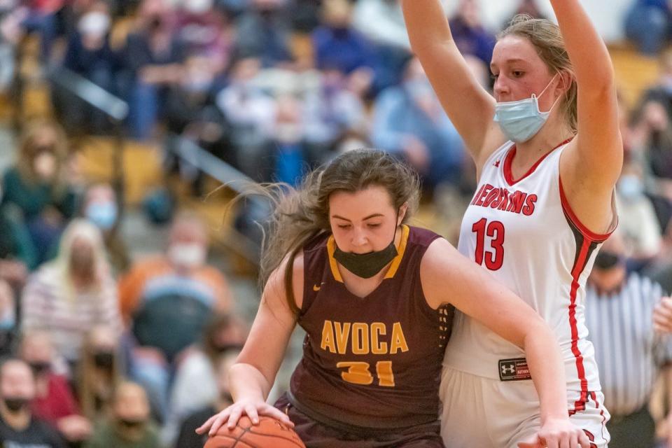 Avoca/Prattsburgh's Riley Stowe drives to the hoop as Canisteo-Greenwood's Brooke Burd defends.