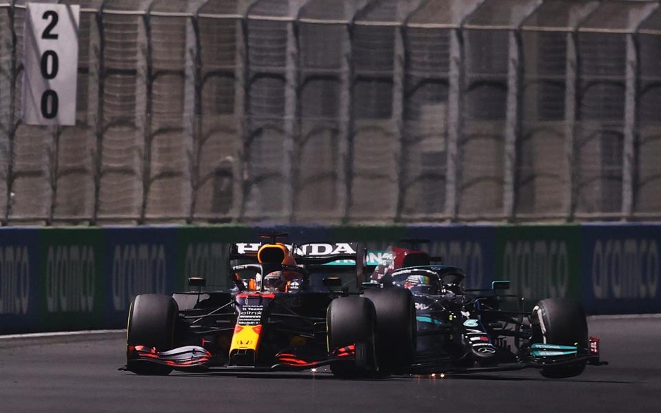 Max Verstappen of the Netherlands driving the (33) Red Bull Racing RB16B Honda and Lewis Hamilton of Great Britain driving the (44) Mercedes AMG Petronas F1 Team Mercedes W12 collide during the F1 Grand Prix of Saudi Arabia at Jeddah Corniche Circuit on December 05, 2021 in Jeddah, Saudi Arabia - Lars Baron/Getty Images