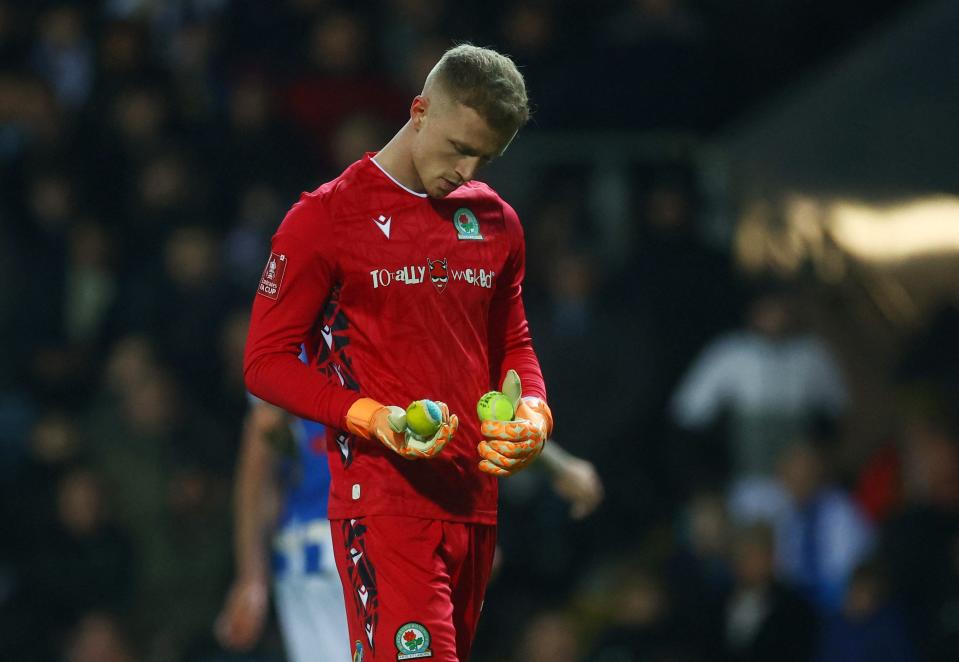 Blackburn Rovers' Aynsley Pears collects tennis balls thrown onto the pitch by fans (Action Images via Reuters)