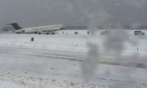 A Delta jet which skidded off the runway at LaGuardia airport is attended by emergency personnel in New York City March 5, 2015. REUTERS/Kristina Grossmann