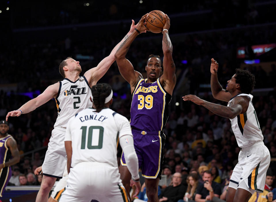LOS ANGELES, CALIFORNIA - OCTOBER 25:  Dwight Howard #39 of the Los Angeles Lakers grabs a rebound in front of Ed Davis #17 and Mike Conley #10 of the Utah Jazz, as he is fouled by Joe Ingles #2, during the first half at Staples Center on October 25, 2019 in Los Angeles, California. (Photo by Harry How/Getty Images)
