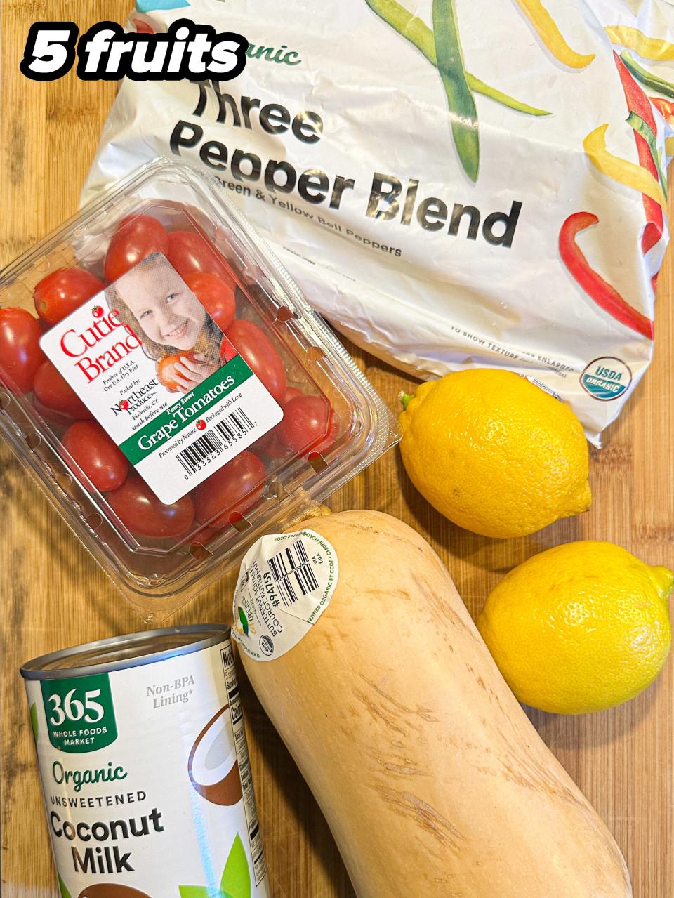 Groceries on counter: Three Pepper Blend bag, small tomato pack, coconut milk can, butternut squash, two lemons