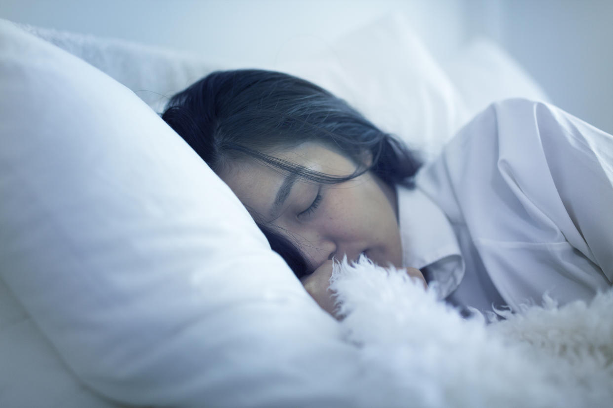 woman sleeping in bed (Getty Images)