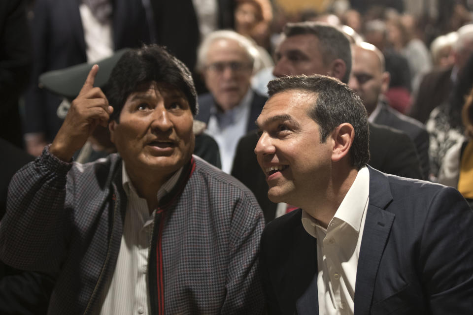 Bolivian President Evo Morales chats with Greek Prime Minister Alexis Tsipras during a conference in Athens, on Thursday, March 14, 2019. Morales is in Greece on a two-day official visit.(AP Photo/Petros Giannakouris)
