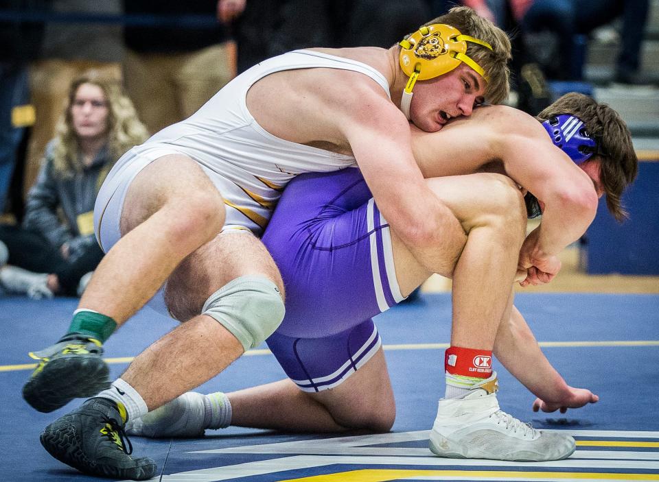 Monroe Central's Joel Kennedy battles Muncie Central's Titus Waters in the 220-pound wrestling sectional final at Delta High School Saturday, Jan. 29, 2022.