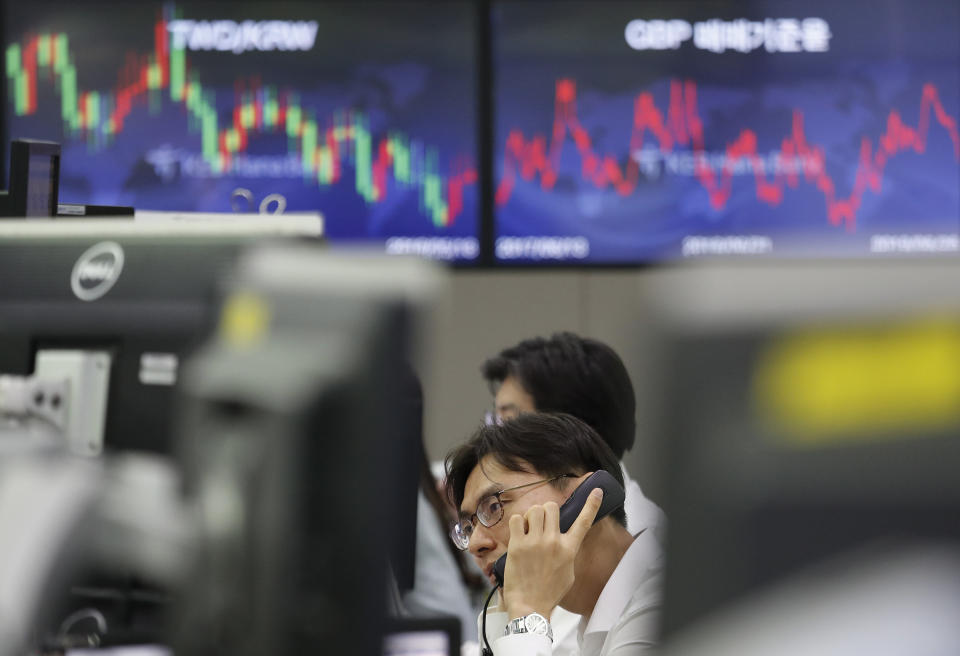 A currency trader talks on phone at the foreign exchange dealing room of the KEB Hana Bank headquarters in Seoul, South Korea, Wednesday, June 26, 2019. Asian shares were mostly lower Wednesday as investors awaited developments on the trade friction between the U.S. and China at the Group of 20 meeting of major economies in Japan later in the week. (AP Photo/Ahn Young-joon)