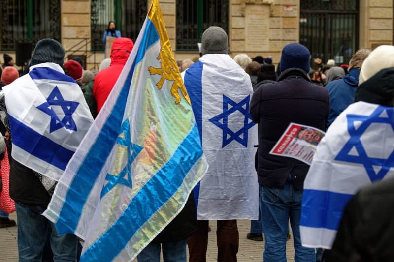 People stand with Israeli flags during the 