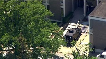 Police tactical team members arrive outside the ABC 2 news station after a possibly armed suspect crashed a vehicle into the Maryland television news station and barricaded himself inside the building, in Towson, Maryland, in this still image taken from video on May 13, 2014. REUTERS/Courtesy-WBAL-TV/Handout via Reuters