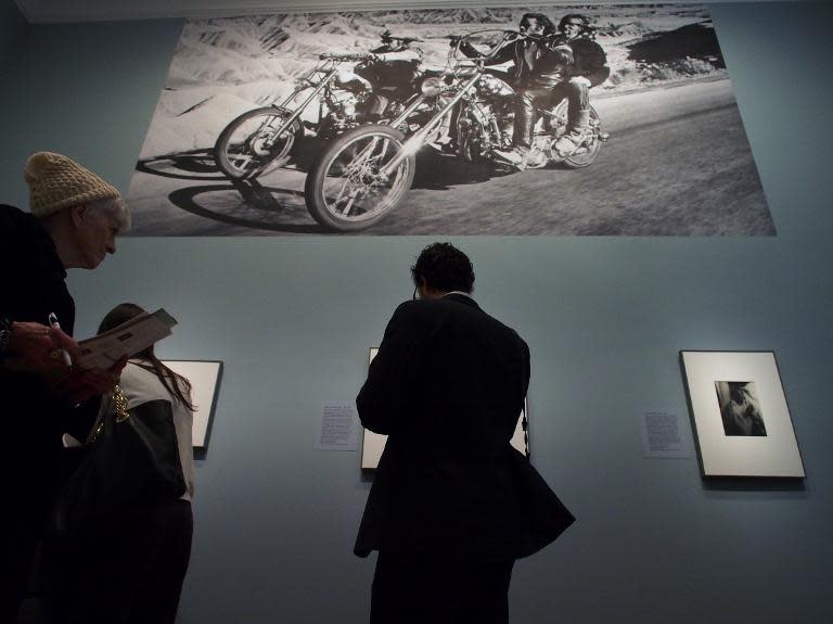 A poster-sized still from the 1969 road movie "Easy Rider" looms over museum-goers at a February 5, 2014 press preview of the "American Cool" exhibition at the National Portrait Gallery in Washington, DC