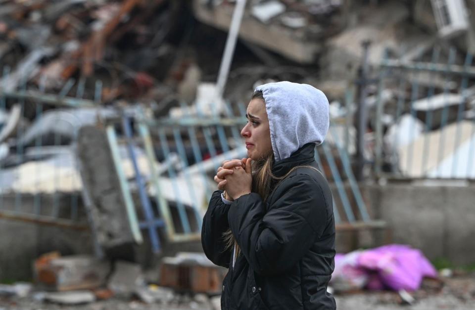 <p>HATAY, TURKIYE - FEBRUARY 06: A woman cries near a collapsed building at Guzelburc neighborhood after 7.7 magnitude earthquake hits Hatay, Turkiye on February 06, 2023. Disaster and Emergency Management Authority (AFAD) of Turkiye said the 7.7 magnitude quake struck at 4.17 a.m. (0117GMT) and was centered in the Pazarcik district in Turkiyeâs southern province of Kahramanmaras. Gaziantep, Sanliurfa, Diyarbakir, Adana, Adiyaman, Malatya, Osmaniye, Hatay, and Kilis provinces are heavily affected by the quake. (Photo by Ercin Erturk/Anadolu Agency via Getty Images)</p> 