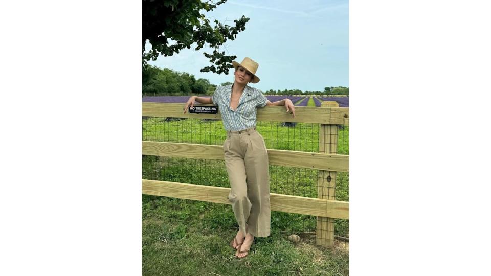 JLo wore her vintage-style piece with camel-hued trousers and tan flip-flops