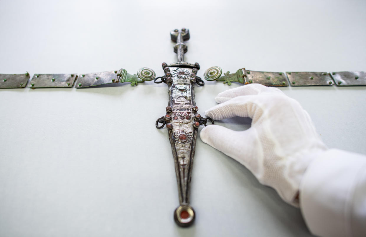 14 February 2020, North Rhine-Westphalia, Münster: A 2000 year old dagger and weapon belt of a legionary lies on a table of the LWL-Archaeology for Westphalia. Archaeologists of the Landschaftsverband Westfalen-Lippe (LWL) present an extraordinary weapon find of a legionary. A rare Roman weapon has been discovered in the Roman burial ground at Haltern am See and has been restored in an elaborate process. It's a dagger with a belt of arms. The experts from the LWL restoration workshop explain how 2000 year old metal and glass were made visible again. Photo: Guido Kirchner/dpa (Photo by Guido Kirchner/picture alliance via Getty Images)