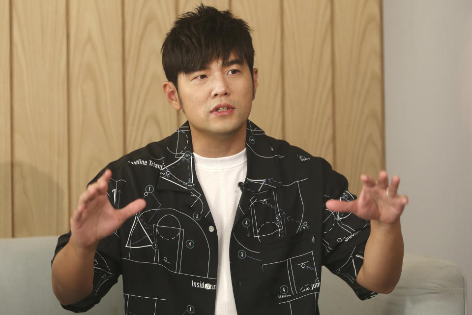 In this Sunday, April 26, 2020, photo, Mandopop superstar Jay Chou gestures while talking about his latest Netflix show "J-Style Trip" and life with his children during an interview with The Associated Press in Taipei, Taiwan. (AP Photo/Chiang Ying-ying)