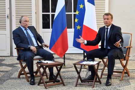 FILE PHOTO: French President Emmanuel Macron meets with Russia's President Vladimir Putin, at his summer retreat of the Bregancon fortress on the Mediterranean coast, near the village of Bormes-les-Mimosas