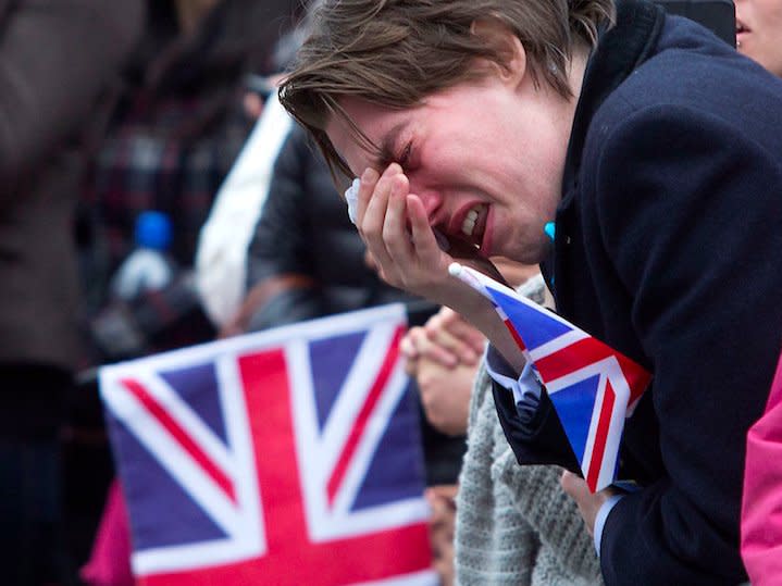 A member of public weeps as the coffin of former British prime minister Margaret Thatcher is transported from St Clement Danes church towards St Paul's Cathedral during her funeral procession, in London April 17, 2013. Thatcher, who was Conservative prime minister between 1979 and 1990, died on April 8 at the age of 87.