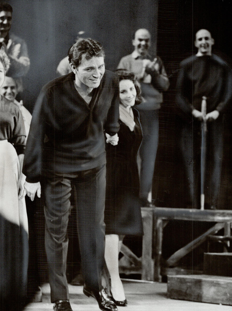 A shy Elizabeth Taylor hides behind new husband Richard Burton as he takes a bow in Hamlet (Photo by Rick Eglinton/Toronto Star via Getty Images)