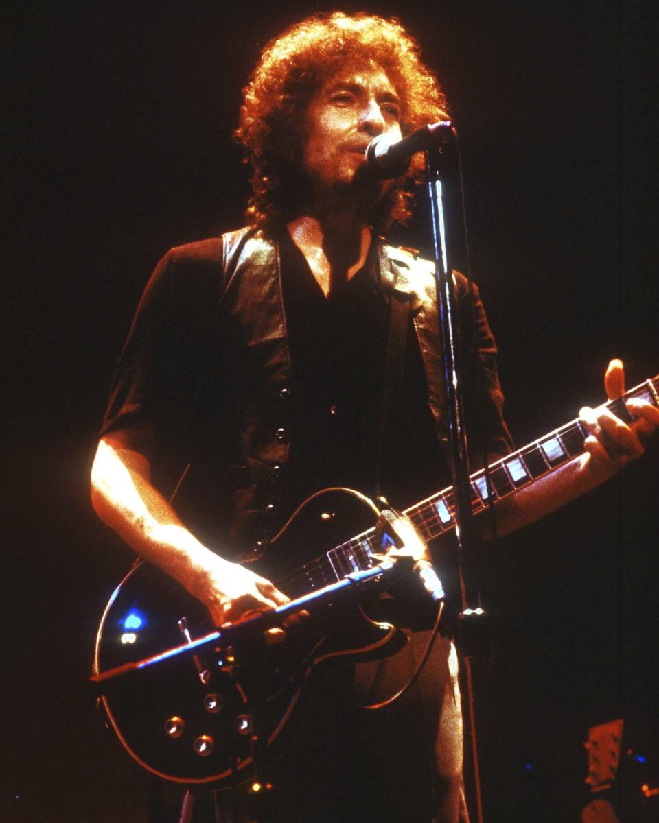 <p>After converting to Evangelical Christianity, Jewish-raised Dylan entered a new musical phase as he released three contemporary gospel music albums between 1979 and 1981: <i>Slow Train Coming</i>, <i>Saved</i>, and <i>Shot of Love</i>.</p> <p>The single "Gotta Save Somebody," off <i>Slow Train Coming</i>, <a href="https://www.grammy.com/artists/bob-dylan/3014" rel="nofollow noopener" target="_blank" data-ylk="slk:won a Grammy" class="link ">won a Grammy</a> for best male rock vocal performance in 1980.</p>