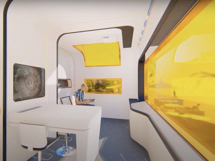a rendering of the interior of the Cube Two X with yellow tinted windows, a person standing in the kitchen,