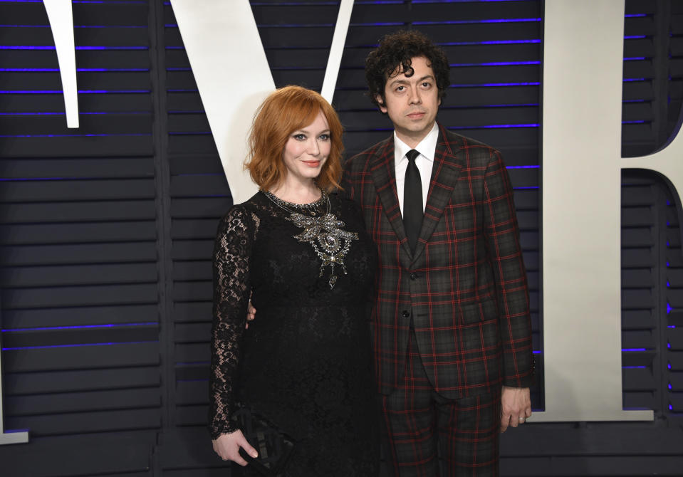 FILE - In this Feb. 24, 2019 file photo, Christina Hendricks, left, and Geoffrey Arend arrive at the Vanity Fair Oscar Party in Beverly Hills, Calif. Hendricks filed for divorce Friday, Dec. 13, from her husband of 10 years, actor Geoffrey Arend. Hendricks filed the marriage dissolution documents in Los Angeles Superior Court, citing irreconcilable differences. (Photo by Evan Agostini/Invision/AP, File)
