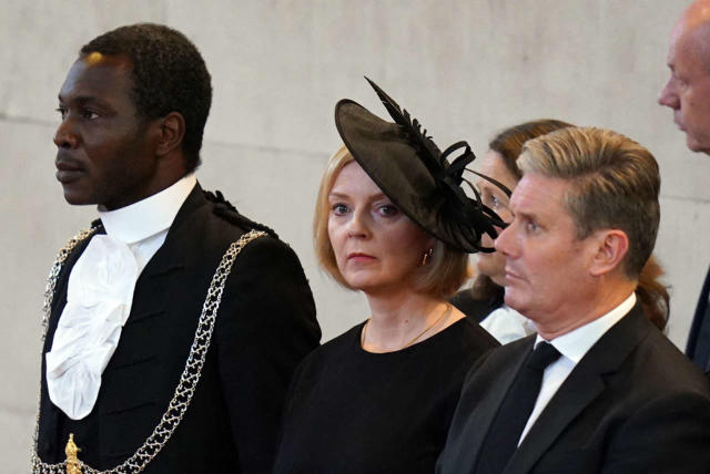 Serjeant-at-Arms of the House of Commons, Ugbana Oyet (L), Britain's Prime Minister Liz Truss (C) and Britain's main opposition Labour Party leader Keir Starmer (R) attend a service for the reception of Queen Elizabeth II's coffin at Westminster Hall, in the Palace of Westminster in London on September 14, 2022, where the coffin of Queen Elizabeth II, will Lie in State. - Queen Elizabeth II will lie in state in Westminster Hall inside the Palace of Westminster, from Wednesday until a few hours before her funeral on Monday, with huge queues expected to file past her coffin to pay their respects. (Photo by Jacob King / POOL / AFP)