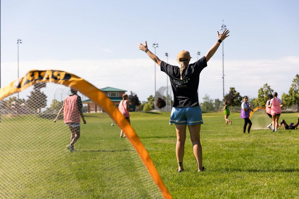 Coach Marli Martin celebrates a score during a scrimmage at a #SheBelongs soccer practice at Lone Peak Park in Sandy on Thursday, July 6, 2023. #SheBelongs is a four-month program bringing together refugee and nonrefugee girls through soccer. | Megan Nielsen, Deseret News