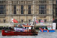 FILE PHOTO: Part of a flotilla of fishing vessels campaigning to leave the European Union sails past Parliament on the river Thames in London