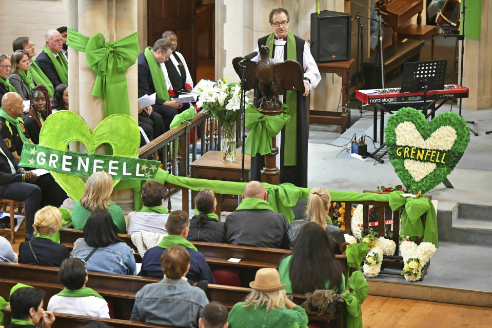 With the colour green having become a mark of remembrance for Grenfell, Dr Graham Tomlin, the Bishop of Kensington, speaks during a service of remembrance at St Helen's church to mark the two-year anniversary of the Grenfell Tower apartment block fire, near to the site of the fire in London, Friday June 14, 2019. Two years after the 24-storey tower-block fire that killed 72 people, campaigners say hundreds of apartment buildings remain at risk of a similar blaze. (Dominic Lipinski/PA via AP)