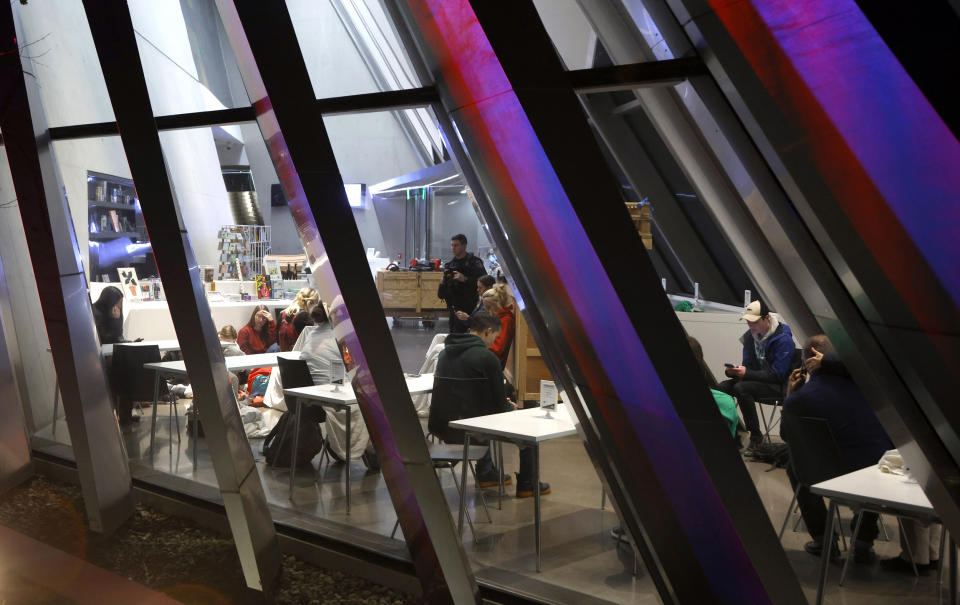 Image: Students shelter in place inside the Broad Art Museum near Berkey Hall on the campus of Michigan State University on Monday. (Al Goldis / AP)