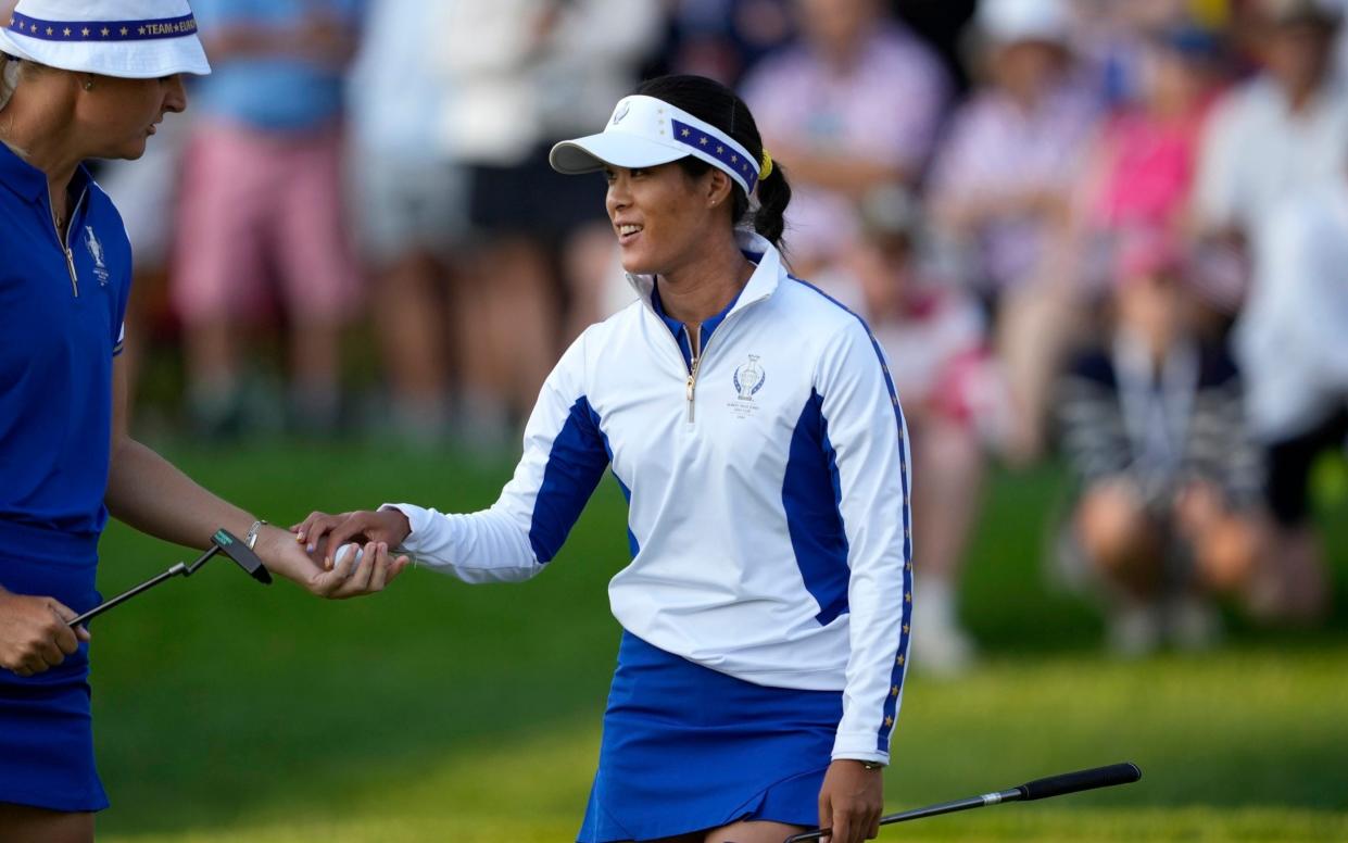 Europe's Celine Boutier, right, hands her ball to teammate Anna Nordqvist on the second hole