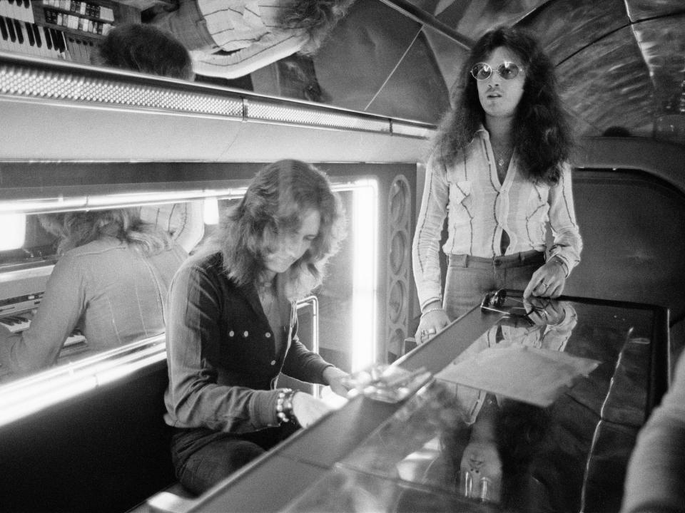 Deep Purple singer David Coverdale (left) and bassist Glenn Hughes (right) at a piano onboard the Starship in 1974.