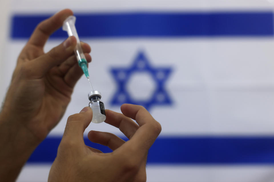 FILE - In this Jan. 7, 2021 file photo, an Israeli military paramedic prepares a Pfizer COVID-19 vaccine, to be administered to elderly people at a medical center in Ashdod, southern Israel. On Friday, April 23 The Associated Press reported on social media posts that misrepresented a report from doctors in Israel claiming shingles may be a side effect of the vaccine. (AP Photo/Tsafrir Abayov, File)