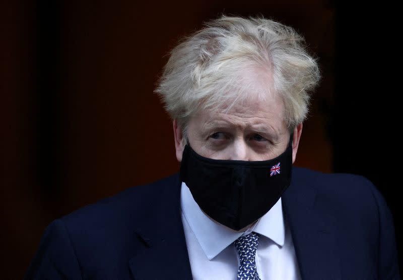 FILE PHOTO: British Prime Minister Johnson walks outside Downing Street in London