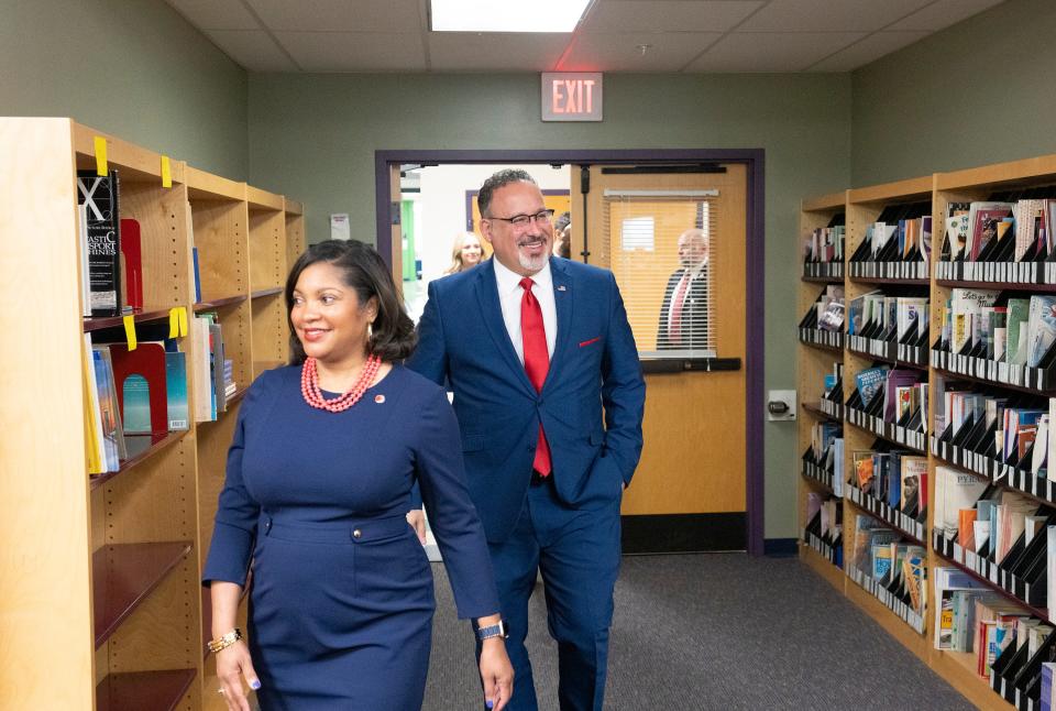 Angela Chapman, superintendent of Columbus City Schools, walks U.S. Secretary of Education Miguel Cardona into the library at Avondale Elementary School in Franklinton.