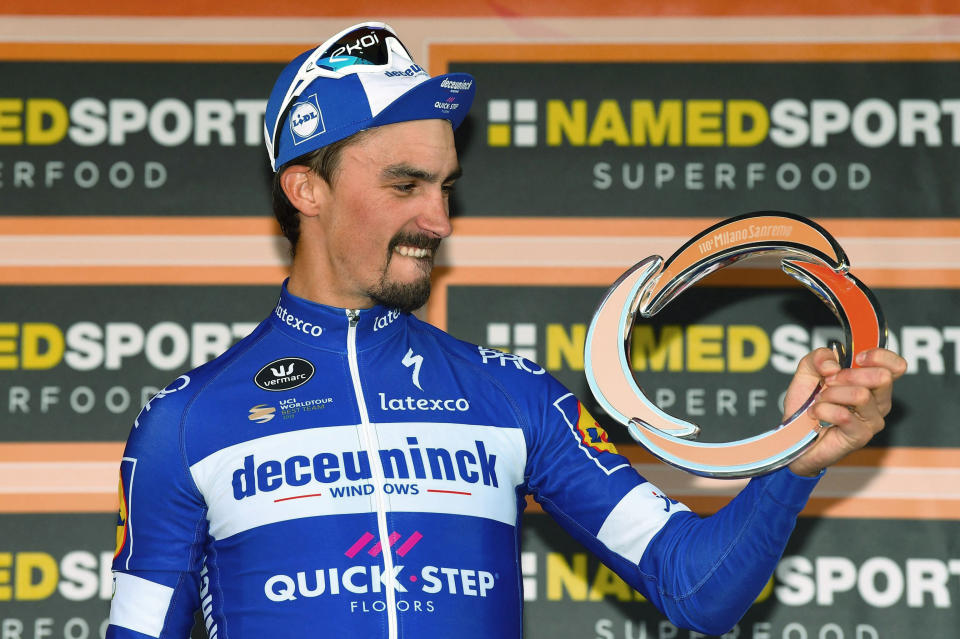 French rider Julian Alaphilippe celebrates on podium after winning the sprint at the end of the 291-kilometer (181-mile) route along the Italian Riviera for the 110th edition of the Milano-Sanremo cycling classic, in Sanremo, Italy, Saturday, March 23, 2019. (Dario Belinghieri/ANSA via AP)