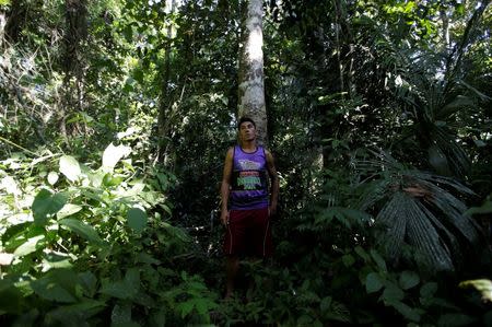 Joao Batista Araujo, 34, who has worked as a rubber extractor since his childhood, poses for a photograph in front of a Seringueira rubber tree in Chico Mendes Extraction Reserve, in Xapuri, Acre state, Brazil, June 24, 2016. REUTERS/Ricardo Moraes