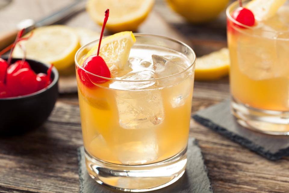 Homemade Whiskey Sour Cocktail Drink with a Cherry Lemon