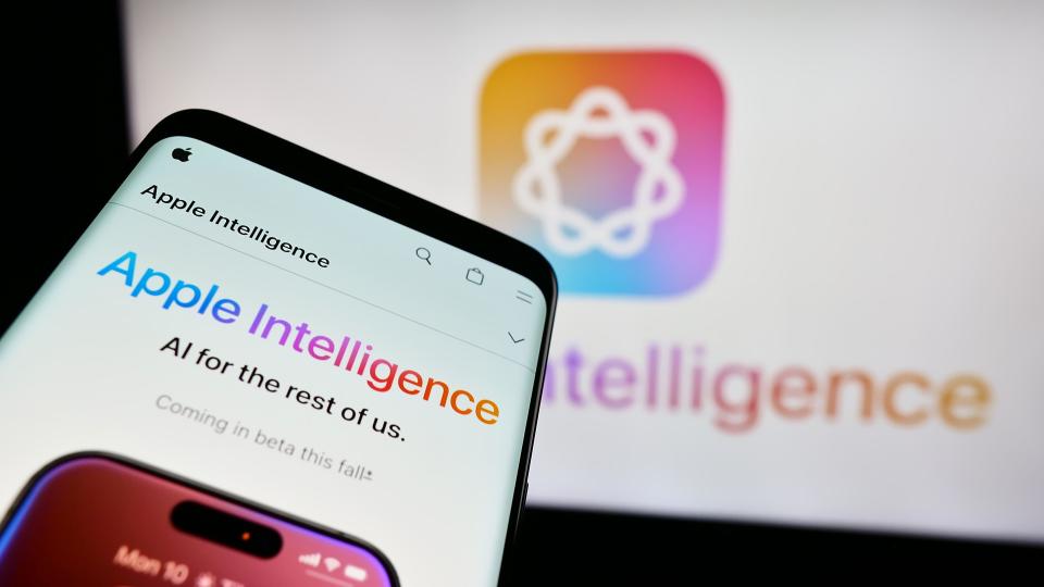 Mobile phone with website of AI platform Apple Intelligence in front of business logo. Focus on top-left of phone display.