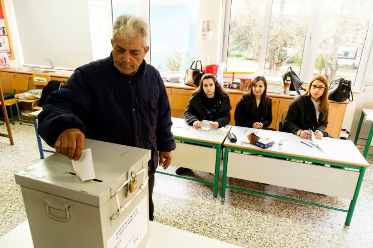 A Greek Cypriot voter casts his ballot in the capital Nicosia on February 4, 2018 during the second round of the Cyprus presidential elections