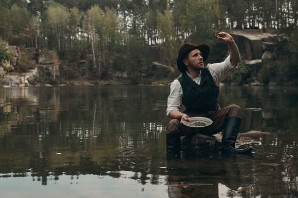 A man panning for gold in a river