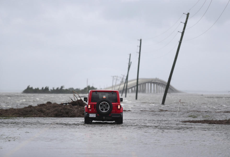 Storm surge from Hurricane Dorian blocks Cedar Island off from the mainland on NC 12 in Atlantic Beach, N.C., after Hurricane Dorian past the coast on Friday, Sept. 6, 2019. (AP Photo/Tom Copeland)