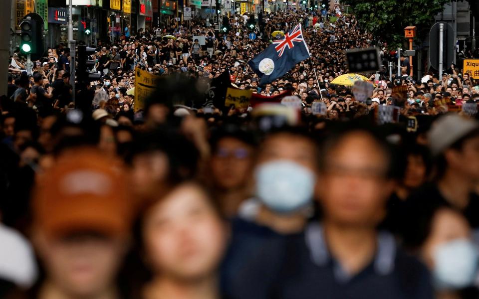 A march of anti-extradition bill protesters in Hong Kong last year - Reuters