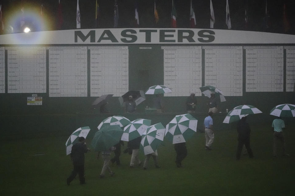 Official leave the Augusta National Golf Course after play was suspended during the first round of the Masters golf tournament Thursday, Nov. 12, 2020, in Augusta, Ga.(AP Photo/Matt Slocum)