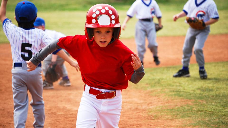 little kid running playing baseball