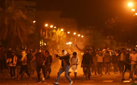 Protesters clash with riot police after the closing campaign rally by Bolivia's President and current presidential candidate for the Movement for Socialism (MAS) party Evo Morales in Santa Cruz - Credit: Reuters