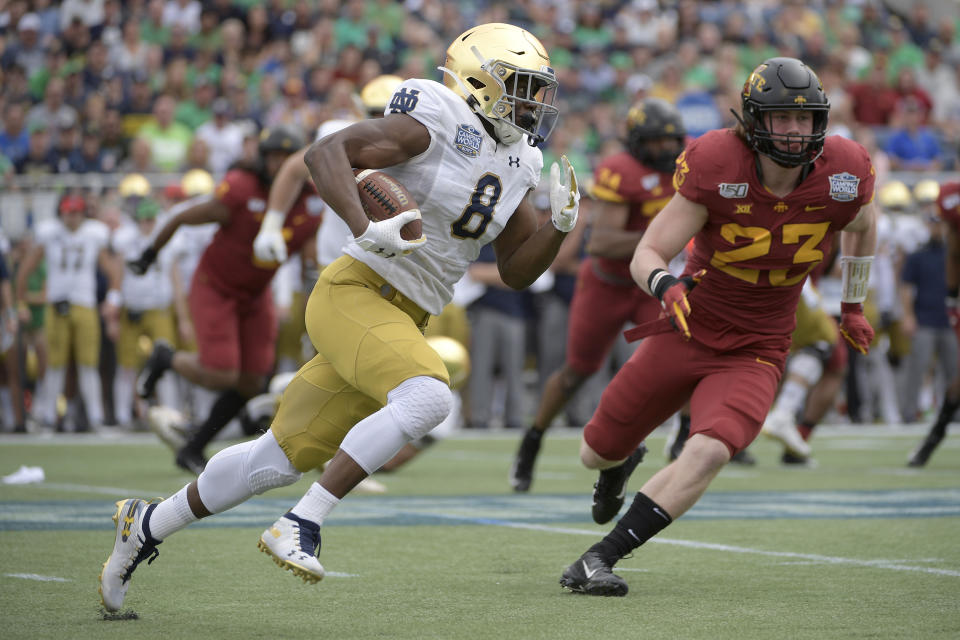 FILE - Notre Dame running back Jafar Armstrong (8) rushes for yardage in front of Iowa State linebacker Mike Rose (23) during the first half of the Camping World Bowl NCAA college football game Saturday, Dec. 28, 2019, in Orlando, Fla. With all the success Notre Dame has enjoyed its last three seasons, amassing a 33-6 record under coach Brian Kelly, it has been the inability to run the football successfully in big games that has curtailed the championship hopes of the Fighting Irish. (AP Photo/Phelan M. Ebenhack)