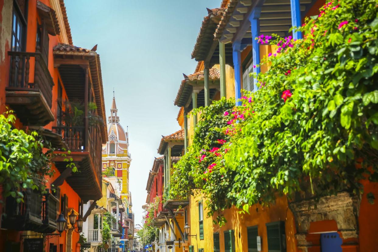 lush balcony planters along the street looking towards town square in the old town of cartagena columbia