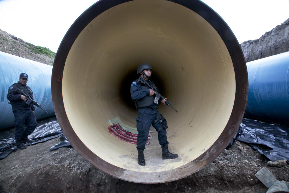 Federal police guard a drainage pipe outside of the Altiplano maximum security prison in Almoloya, west of Mexico City, Sunday, July 12, 2015. (AP Photo/Marco Ugarte)