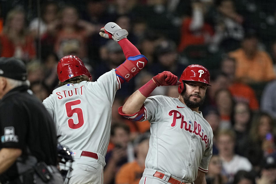 Philadelphia Phillies' Bryson Stott (5) celebrates with Kyle Schwarber after hitting a home run against the Houston Astros during the eighth inning of a baseball game Monday, Oct. 3, 2022, in Houston. (AP Photo/David J. Phillip)