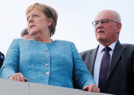 German Chancellor Angela Merkel looks on next to parliamentary group leader of the CDU/CSU fraction Volker Kauder as they visit a test track after the opening ceremony of the new Daimler Testing and Technology Center in Immendingen, Germany September 19, 2018. REUTERS/Arnd Wiegmann