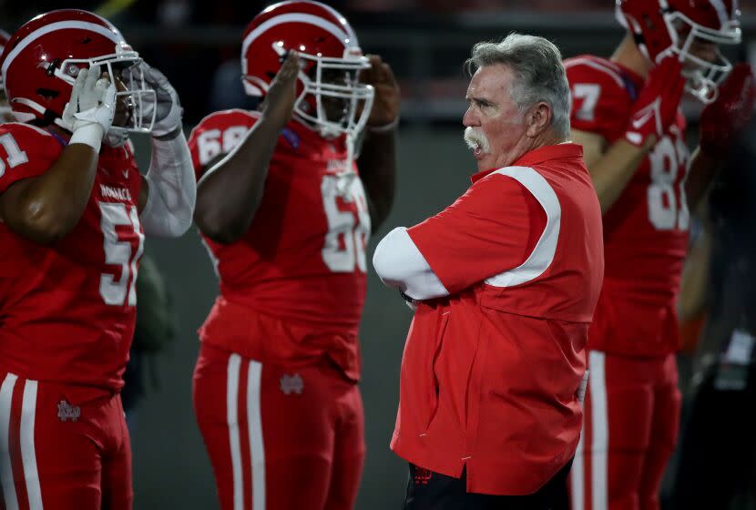 SANTA ANA, CALIF. - OPCT. 7, 2022. Mater Dei head coach Bruce Rollinson watches his team warm up before the game against St. John Bosco at Santa Ana Stadium on Friday night, Oct. 7, 2022. (Luis Sinco / Los Angeles Times)